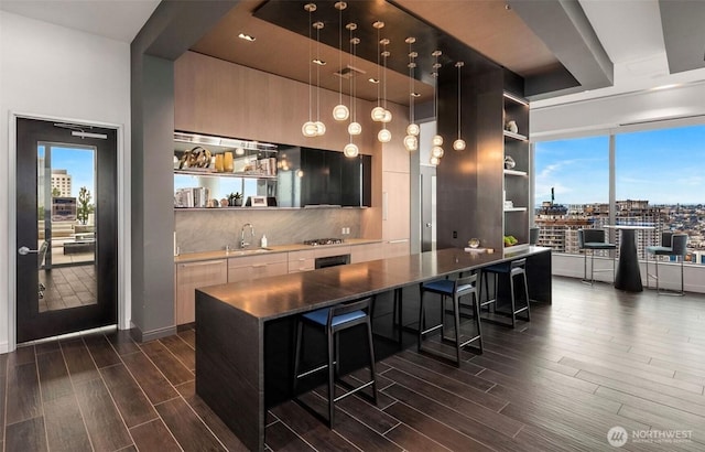 1808 Minor Ave Unit 912, Seattle, WA 98101 - bar area with dark wood-style flooring, hanging light fixtures, a sink, tasteful backsplash, and a raised ceiling