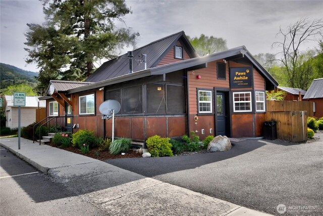 115 Johnson St N Unit 1, 2, 3, Twisp, WA 98856 - view of front of home featuring metal roof, a sunroom, and fence