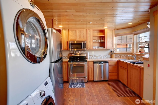 115 Johnson St N Unit 1, 2, 3, Twisp, WA 98856 - kitchen with appliances with stainless steel finishes, stacked washer / dryer, a sink, wood ceiling, and hardwood / wood-style flooring