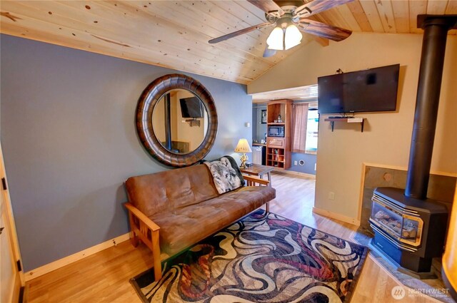 115 Johnson St N Unit 1, 2, 3, Twisp, WA 98856 - sitting room featuring a wood stove, wood finished floors, a ceiling fan, baseboards, and wood ceiling