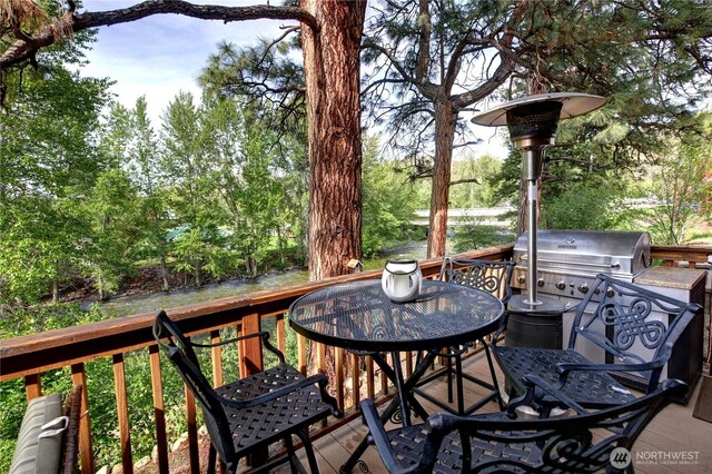115 Johnson St N Unit 1, 2, 3, Twisp, WA 98856 - wooden deck featuring a grill, outdoor dining space, and view of scattered trees