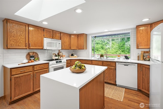 14431 Cascade Dr SE, Snohomish, WA 98296 - kitchen with white appliances, a sink, light wood finished floors, light countertops, and recessed lighting