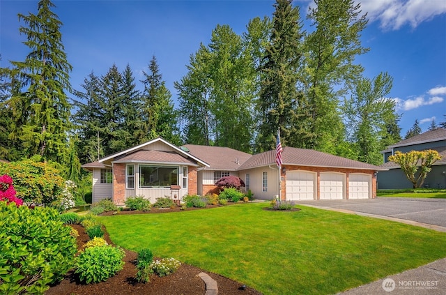 14431 Cascade Dr SE, Snohomish, WA 98296 - view of front of home featuring a front yard, asphalt driveway, and an attached garage