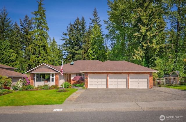 14431 Cascade Dr SE, Snohomish, WA 98296 - view of front of house featuring an attached garage, driveway, and brick siding