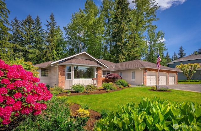 14431 Cascade Dr SE, Snohomish, WA 98296 - ranch-style home featuring a garage, a front lawn, asphalt driveway, and brick siding