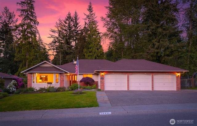 14431 Cascade Dr SE, Snohomish, WA 98296 - ranch-style house with an attached garage, asphalt driveway, brick siding, and a front yard