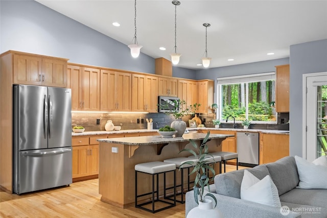 10810 63rd Ave NW, Gig Harbor, WA 98332 - kitchen featuring appliances with stainless steel finishes, plenty of natural light, a breakfast bar, tasteful backsplash, and recessed lighting
