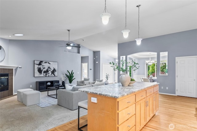 10810 63rd Ave NW, Gig Harbor, WA 98332 - kitchen featuring vaulted ceiling, arched walkways, light wood-type flooring, a ceiling fan, and decorative light fixtures