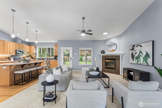 10810 63rd Ave NW, Gig Harbor, WA 98332 - living area featuring recessed lighting, a ceiling fan, a tile fireplace, and light wood-type flooring