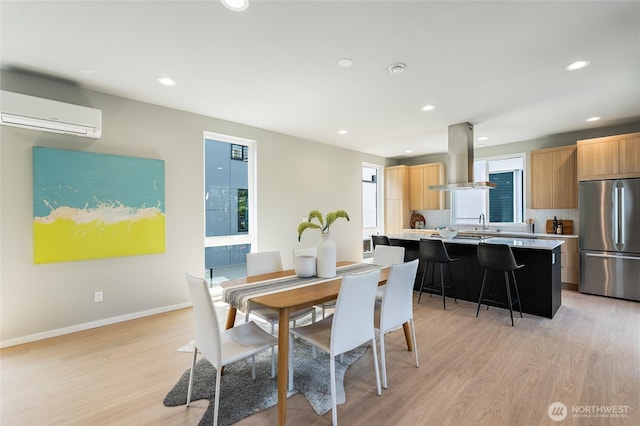 1801 NW 65th St Unit C, Seattle, WA 98117 - dining area featuring light wood-type flooring, a wall mounted air conditioner, recessed lighting, and baseboards