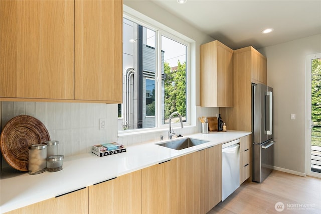 1801 NW 65th St Unit C, Seattle, WA 98117 - kitchen featuring a sink, appliances with stainless steel finishes, light wood-type flooring, light brown cabinetry, and modern cabinets
