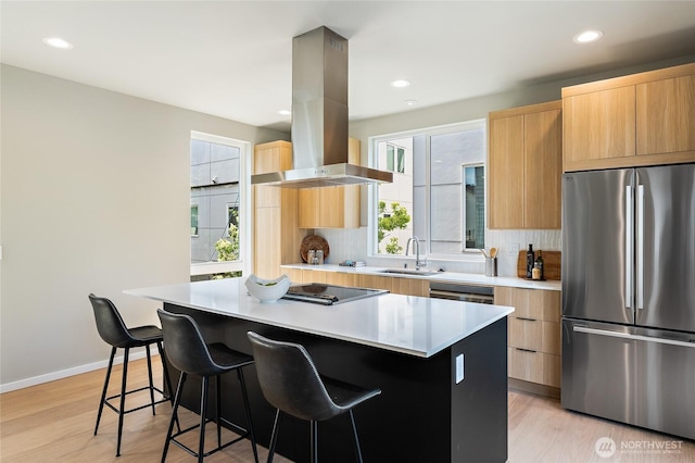 1801 NW 65th St Unit C, Seattle, WA 98117 - kitchen with freestanding refrigerator, island exhaust hood, a sink, modern cabinets, and a center island