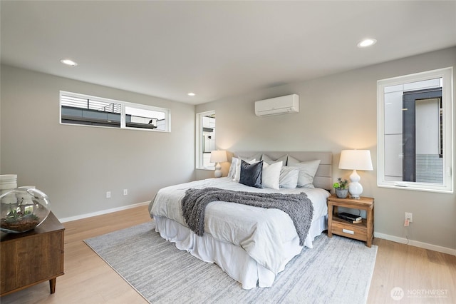 1801 NW 65th St Unit C, Seattle, WA 98117 - bedroom featuring a wall unit AC, wood finished floors, baseboards, and recessed lighting