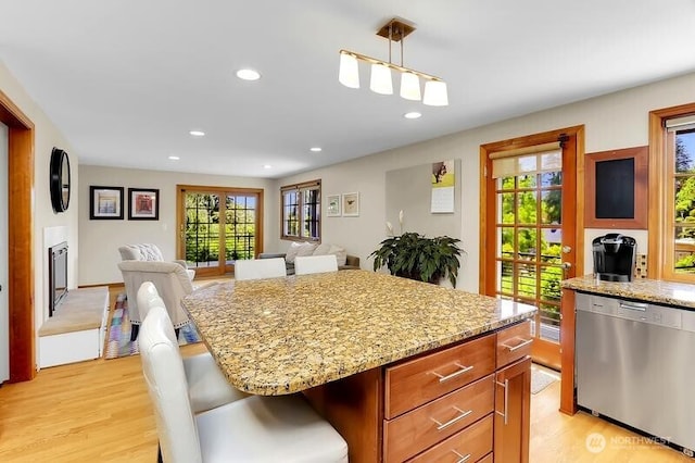 kitchen featuring dishwasher, open floor plan, light wood-style floors, healthy amount of natural light, and recessed lighting
