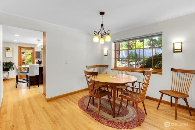 dining room featuring light wood finished floors, healthy amount of natural light, baseboards, and recessed lighting
