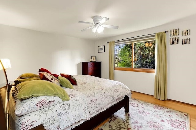 bedroom featuring wood finished floors and a ceiling fan