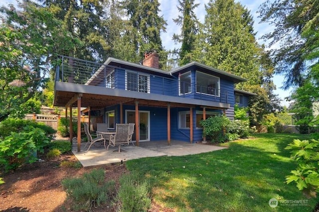 rear view of house featuring a patio and a chimney