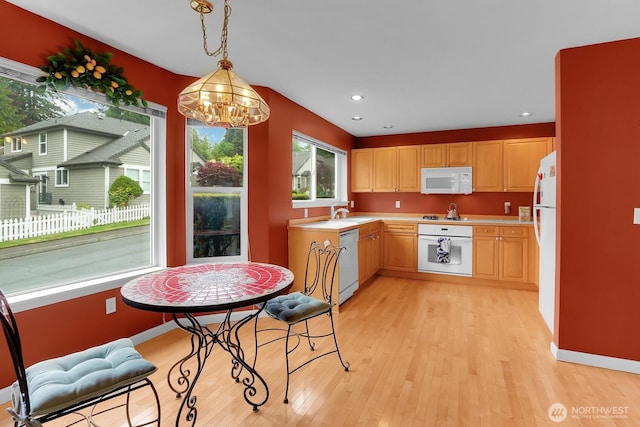 kitchen featuring white appliances, light countertops, light wood-style floors, light brown cabinets, and recessed lighting