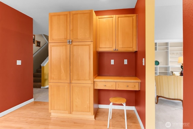 kitchen featuring light wood-style flooring and baseboards