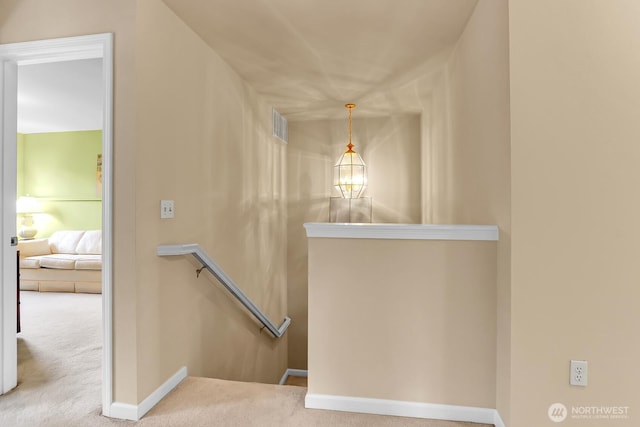 stairway featuring carpet flooring and baseboards