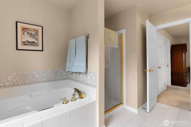 full bathroom featuring tile patterned floors, a stall shower, a garden tub, and baseboards