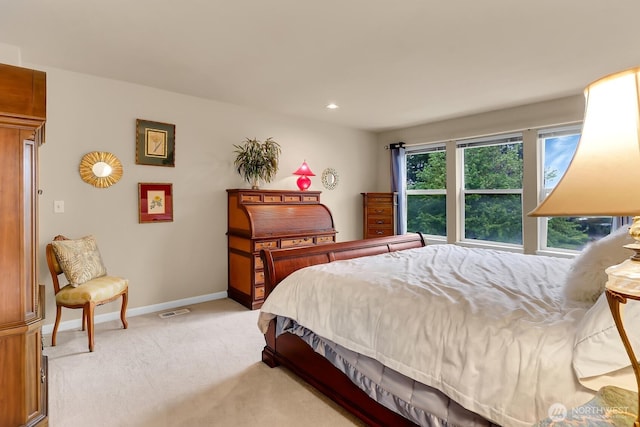 bedroom featuring light colored carpet, baseboards, and recessed lighting
