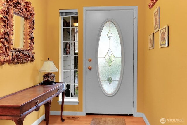 entrance foyer featuring baseboards and wood finished floors