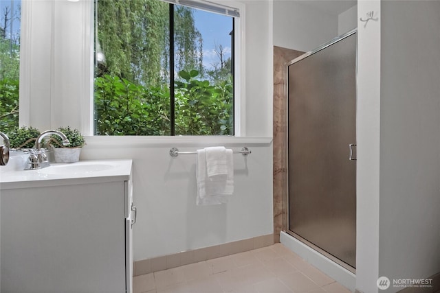 bathroom featuring a stall shower, vanity, and tile patterned flooring