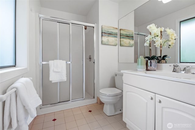 bathroom with toilet, a stall shower, tile patterned floors, and vanity