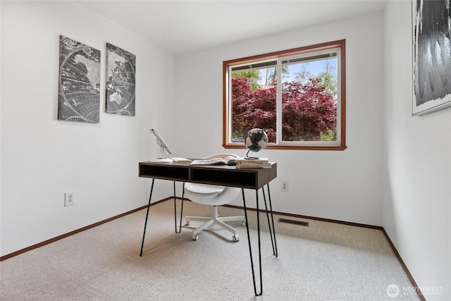carpeted office space with baseboards