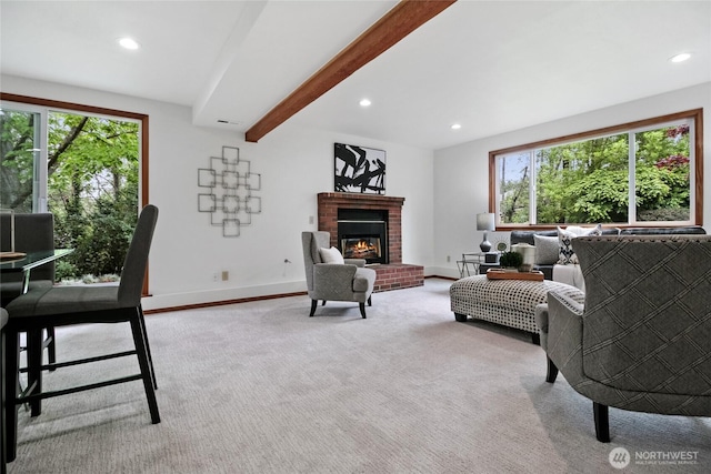 living area with plenty of natural light, recessed lighting, beamed ceiling, a brick fireplace, and baseboards