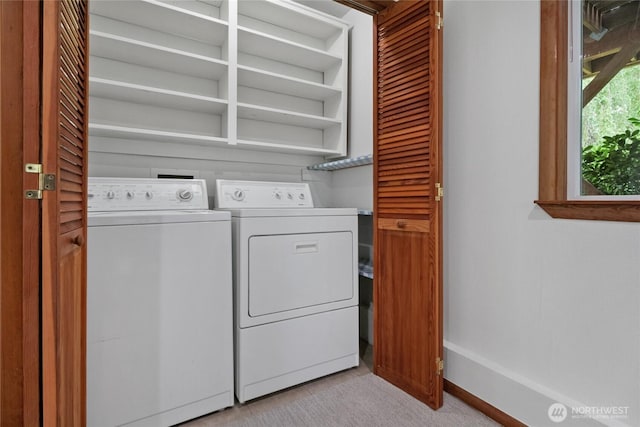washroom with separate washer and dryer, baseboards, and light colored carpet