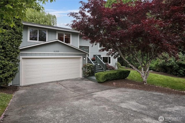view of front of house featuring driveway and stairs