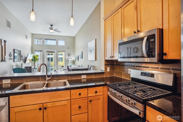 1705 Dock St Unit 520, Tacoma, WA 98402 - kitchen with appliances with stainless steel finishes, a sink, open floor plan, and hanging light fixtures