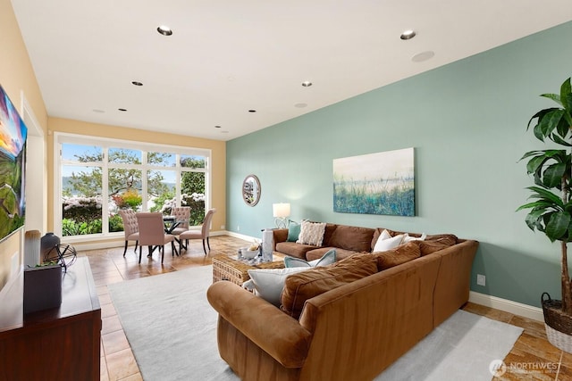 living area with baseboards and recessed lighting