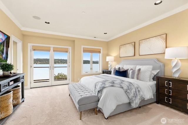 bedroom with access to exterior, light carpet, ornamental molding, a water view, and recessed lighting