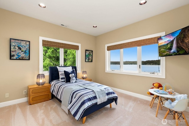 bedroom with baseboards, light colored carpet, and recessed lighting