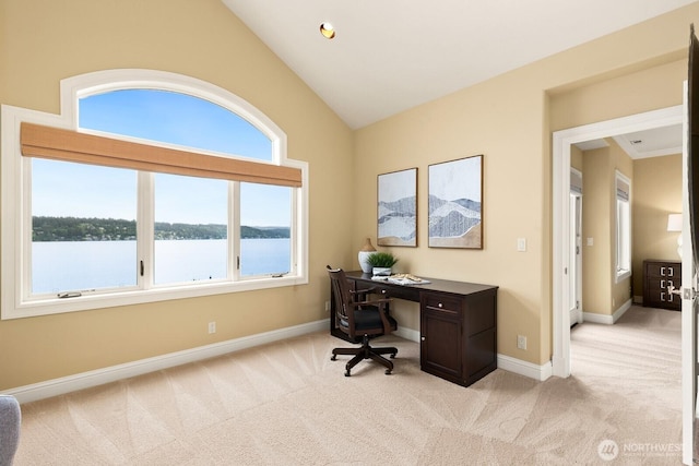 home office with light colored carpet, lofted ceiling, baseboards, and a water view