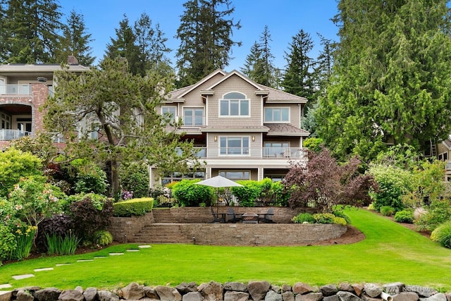back of property with a lawn