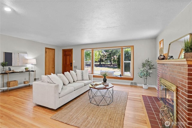 1510 N Mason Ave, Tacoma, WA 98406 - living area with a textured ceiling, wood finished floors, a fireplace, baseboards, and recessed lighting