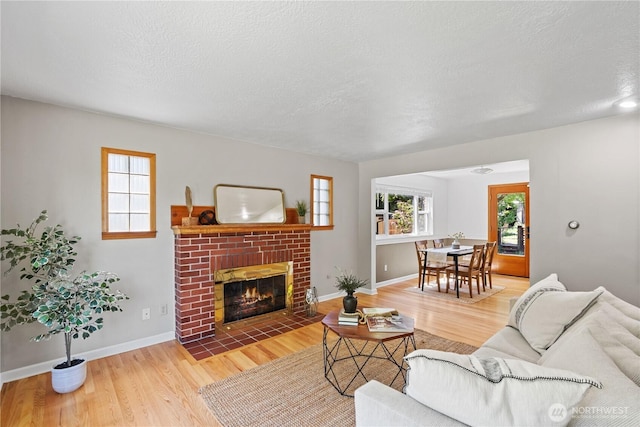 1510 N Mason Ave, Tacoma, WA 98406 - living area with wood finished floors, a brick fireplace, baseboards, and a textured ceiling