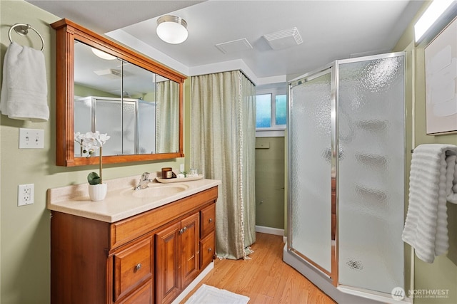 1510 N Mason Ave, Tacoma, WA 98406 - bathroom featuring wood finished floors, a shower stall, and vanity