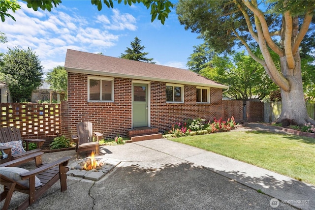 1510 N Mason Ave, Tacoma, WA 98406 - view of front of property featuring brick siding, a fire pit, entry steps, a patio area, and roof with shingles