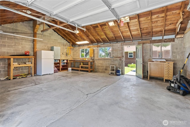 1510 N Mason Ave, Tacoma, WA 98406 - garage featuring freestanding refrigerator and concrete block wall