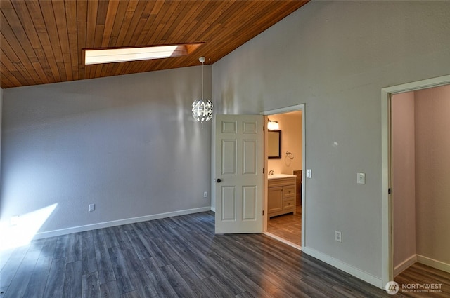 empty room with a skylight, high vaulted ceiling, wooden ceiling, baseboards, and dark wood-style flooring
