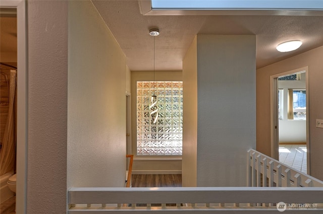 hallway featuring a textured wall