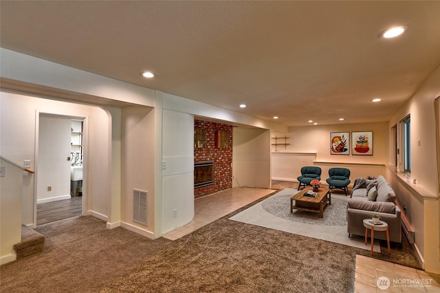 living area featuring carpet flooring, recessed lighting, a fireplace, and baseboards