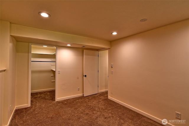 unfurnished bedroom featuring carpet flooring, recessed lighting, baseboards, and a spacious closet