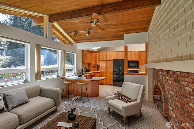 17418 NE 33rd St, Redmond, WA 98052 - living area with light tile patterned floors, wood ceiling with exposed beams, ceiling fan, and high vaulted ceiling