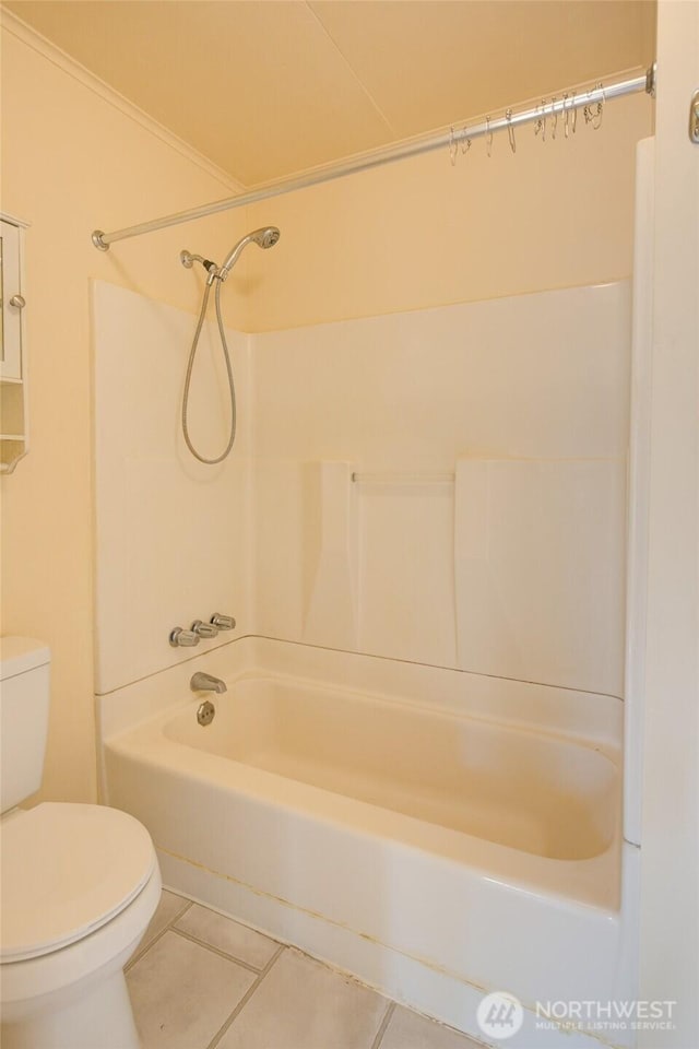 bathroom featuring tile patterned floors, toilet, and shower / bathtub combination
